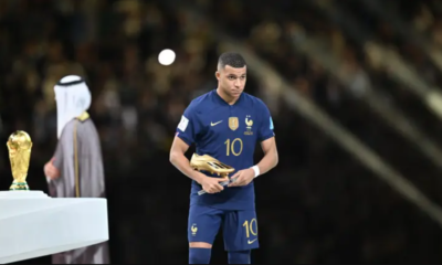 Kylian Mbappe holding the Golden Boot award