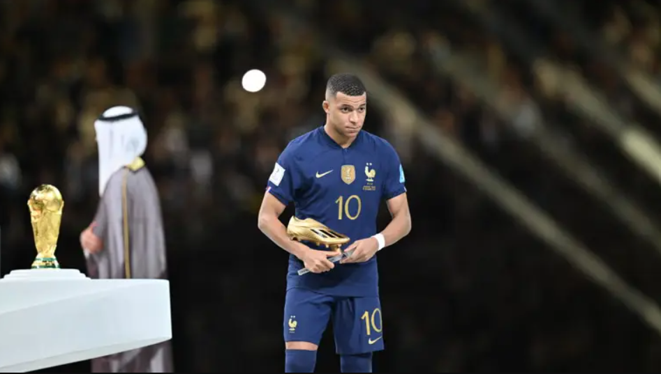 Kylian Mbappe holding the Golden Boot award